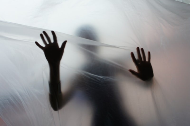 Silhouette of a person behind translucent material