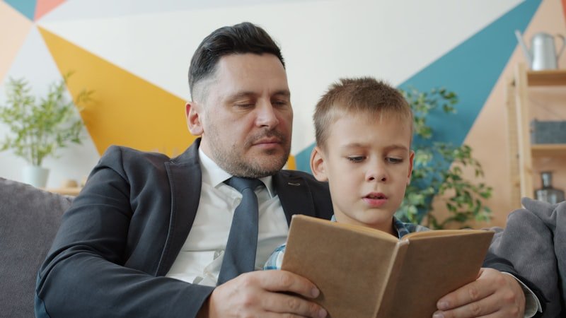 Father and son reading a book together