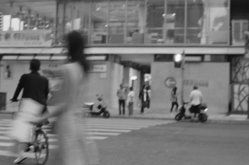 People and traffic crossing a city street.