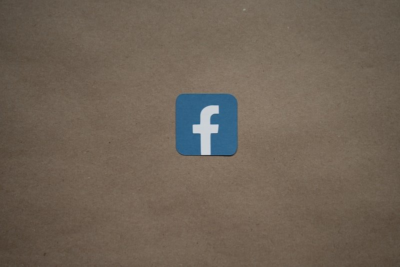 a blue facebook logo on a brown background