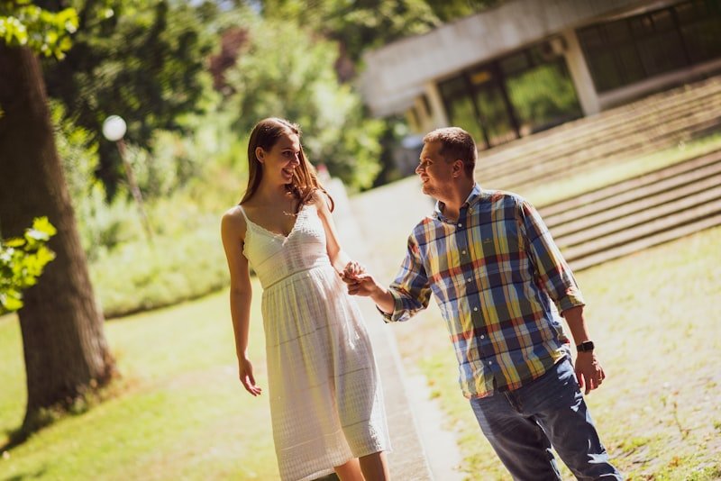 smiling man and woman holding each other hands