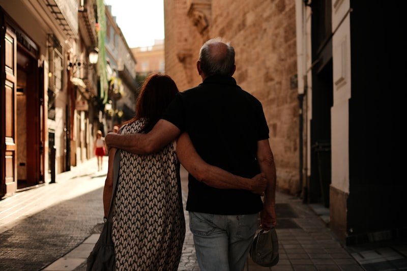 A man and a woman walking down a street