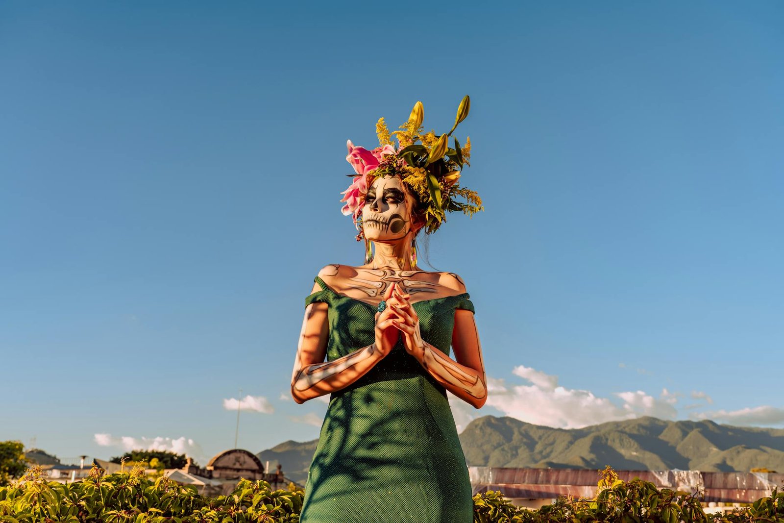 A woman in traditional Day of the Dead makeup and flower crown in Oaxaca, Mexico.