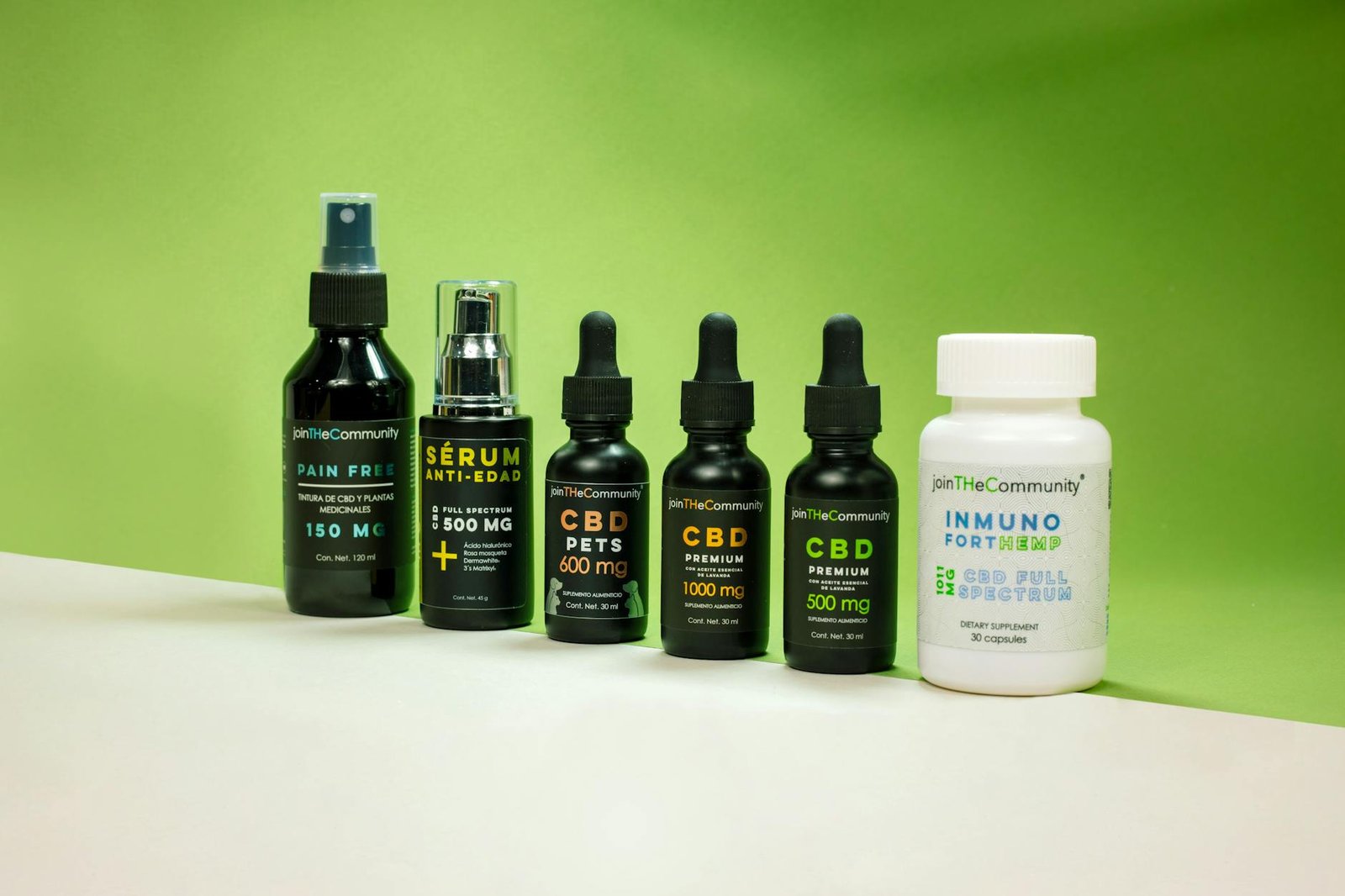 Collection of CBD products including serums and supplements displayed against a green backdrop.