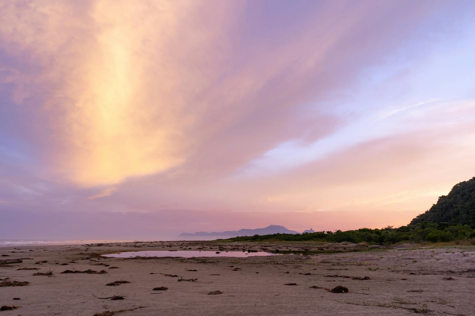Stunning sunset view at Barra do Una beach, showcasing vibrant skies and serene coastline.