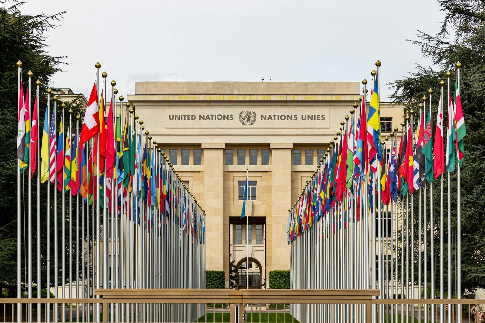 View of the United Nations Office in Geneva adorned with flags of various countries.