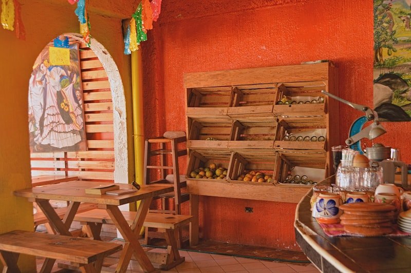 a room with a bunch of wooden chairs and a table