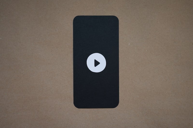 a black device with a play button on it