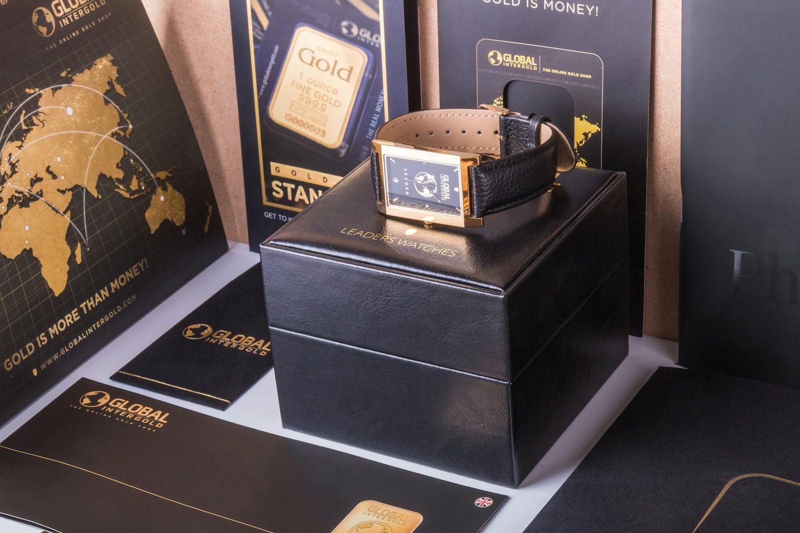 Opulent gold watch displayed with global branding materials, exuding luxury and wealth.