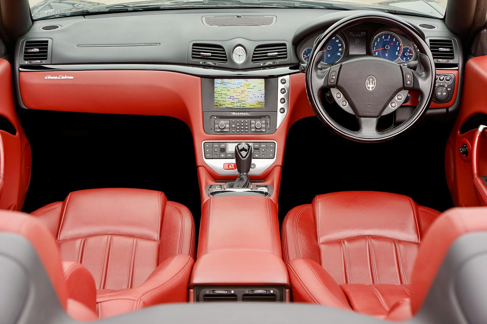 Explore the luxurious Maserati GranCabrio interior with red leather seats and advanced dashboard.