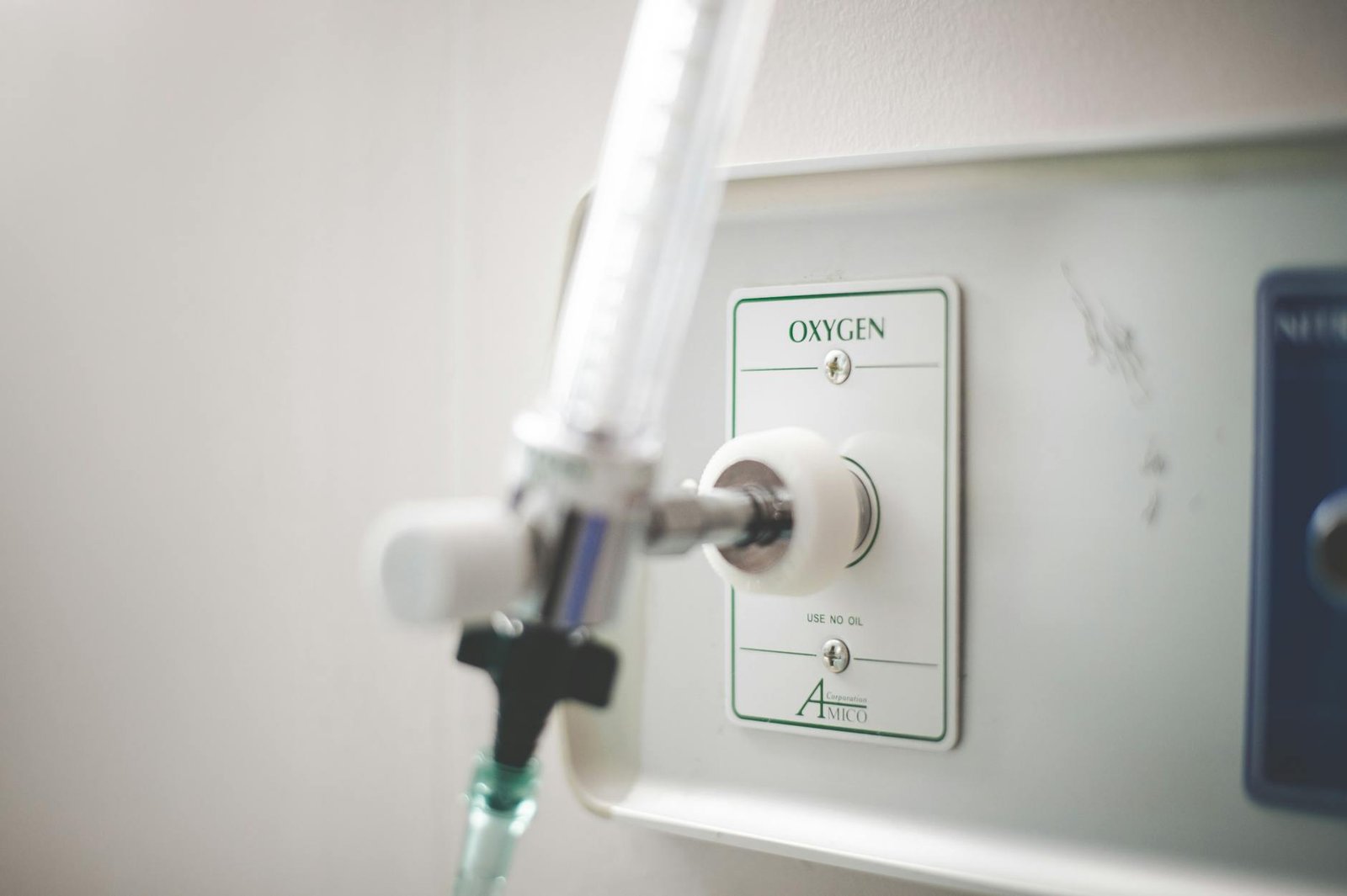A detailed view of an oxygen outlet on a medical wall panel, used in healthcare facilities.