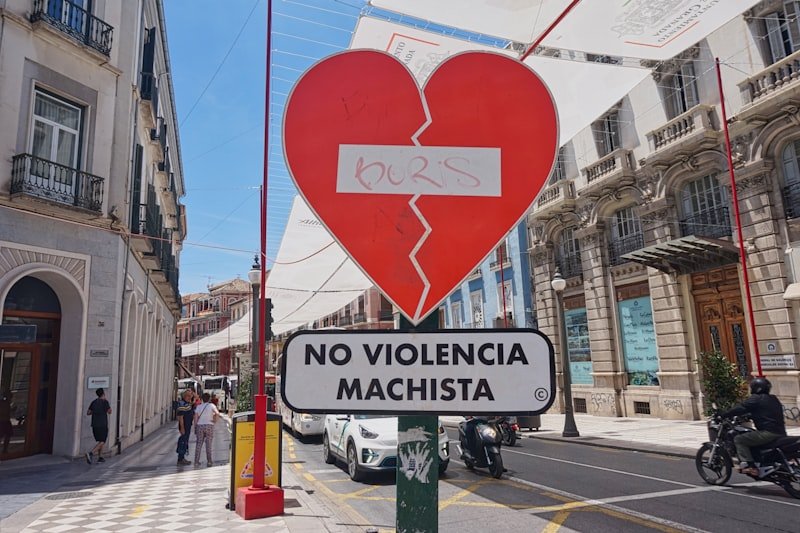 A street sign with a broken heart on it