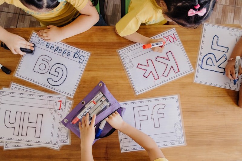 A group of children sitting at a table with paper cut outs