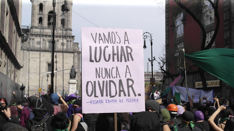 Protest sign reads: 